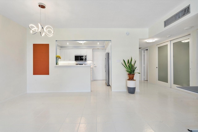 living room with baseboards and visible vents