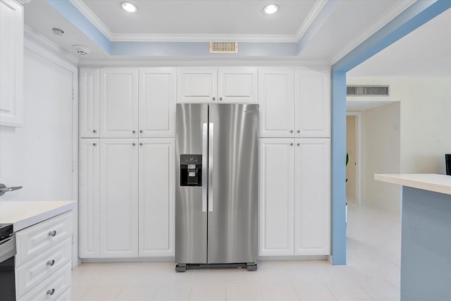 kitchen with white cabinetry, visible vents, and stainless steel fridge