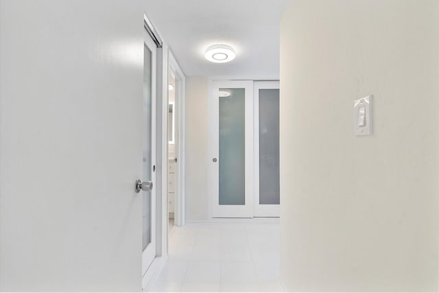 hall featuring light tile patterned flooring