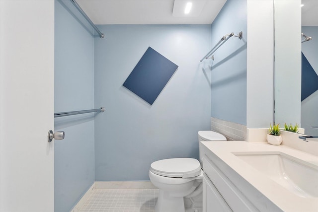 bathroom featuring toilet, tile patterned flooring, and vanity