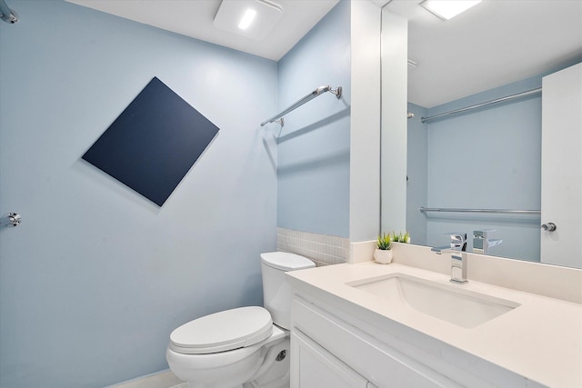 bathroom with toilet and vanity