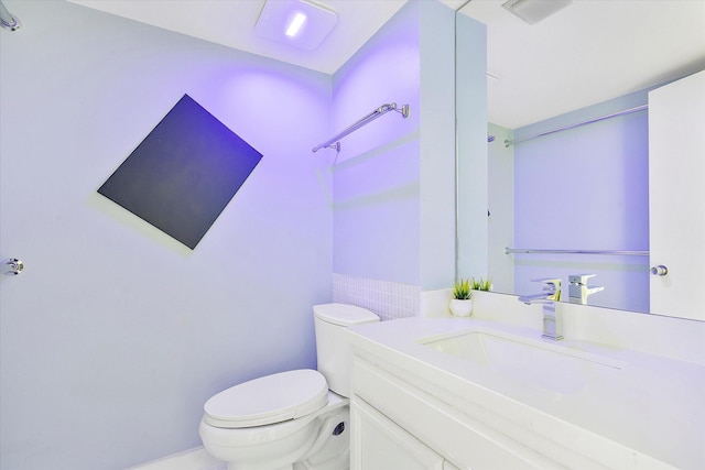 bathroom with toilet and vanity