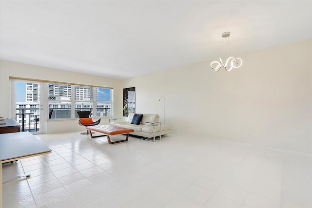 living room with baseboards and a chandelier