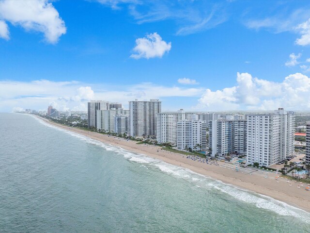 aerial view featuring a view of the beach, a water view, and a view of city