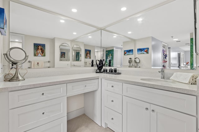 bathroom featuring recessed lighting and vanity