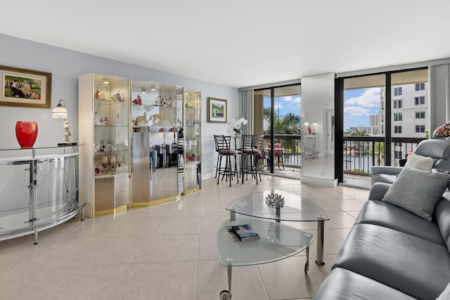 living area with floor to ceiling windows and light tile patterned floors