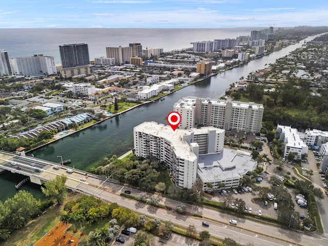 birds eye view of property with a water view and a city view