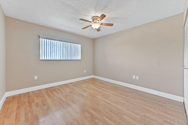 4734 Lucerne Lakes Blvd E Unit 302, Lake Worth, FL 33467 - spare room featuring a ceiling fan, light wood-style flooring, a textured ceiling, and baseboards