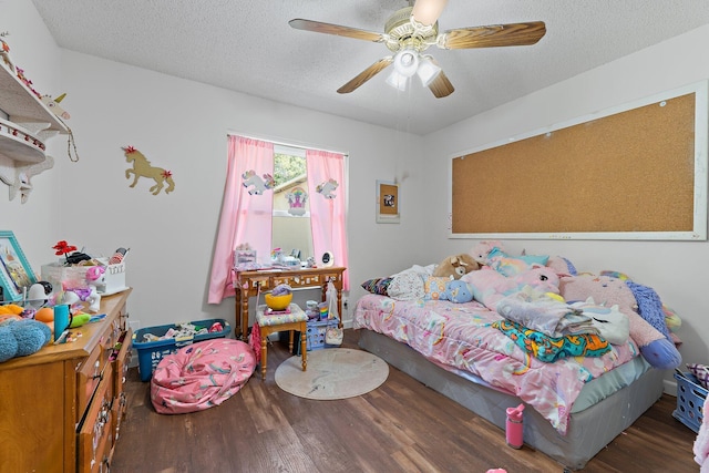 bedroom with wood finished floors, a textured ceiling, and ceiling fan