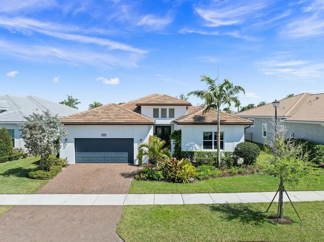 9129 SW Pepoli Way, Port Saint Lucie, FL 34987 - view of front of home with decorative driveway, an attached garage, stucco siding, and a front yard