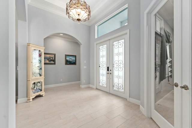 9129 SW Pepoli Way, Port Saint Lucie, FL 34987 - foyer with arched walkways, french doors, a chandelier, ornamental molding, and baseboards