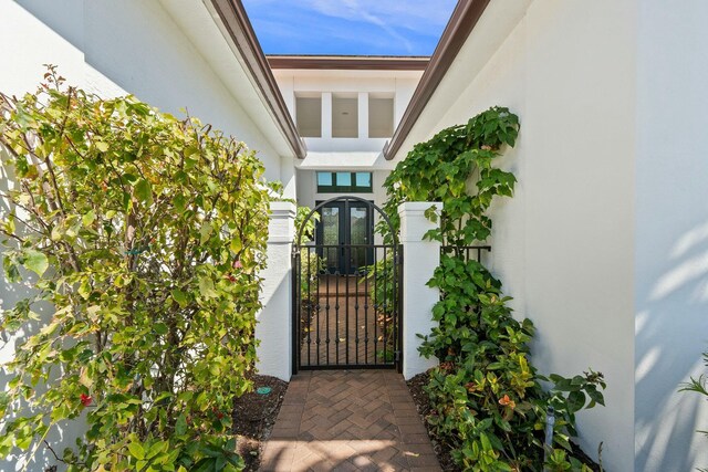 9129 SW Pepoli Way, Port Saint Lucie, FL 34987 - view of exterior entry with stucco siding and a gate
