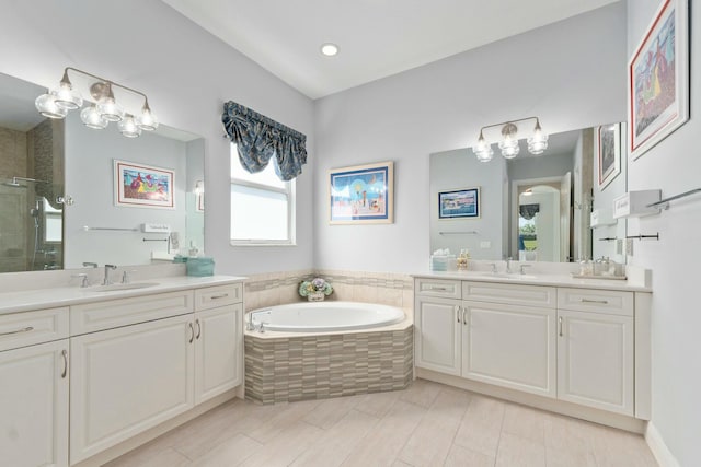 9129 SW Pepoli Way, Port Saint Lucie, FL 34987 - full bath with a stall shower, two vanities, a garden tub, and recessed lighting