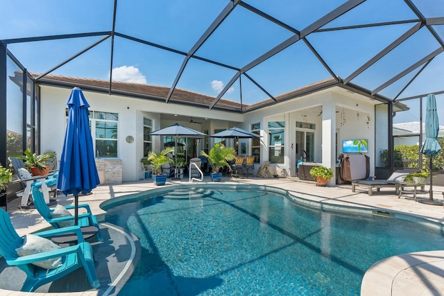 9129 SW Pepoli Way, Port Saint Lucie, FL 34987 - swimming pool featuring a patio, glass enclosure, and a ceiling fan