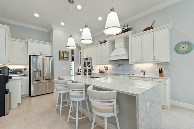 9129 SW Pepoli Way, Port Saint Lucie, FL 34987 - kitchen with stainless steel appliances, custom exhaust hood, backsplash, white cabinets, and recessed lighting