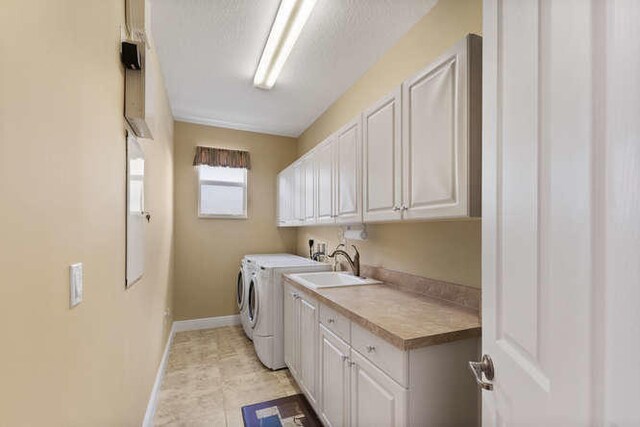 2646 Treanor Ter, Wellington, FL 33414 - laundry area with a sink, cabinet space, baseboards, and washer and clothes dryer