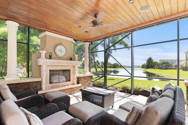 2646 Treanor Ter, Wellington, FL 33414 - sunroom / solarium featuring a water view, wood ceiling, ceiling fan, and ornate columns