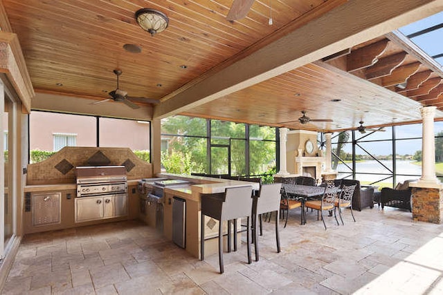 2646 Treanor Ter, Wellington, FL 33414 - view of patio / terrace with a lanai, area for grilling, an outdoor kitchen, and a fireplace