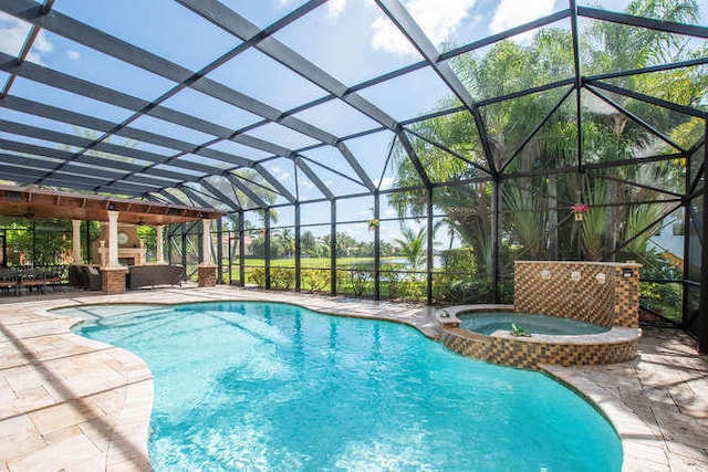 2646 Treanor Ter, Wellington, FL 33414 - view of pool with a pool with connected hot tub, a lanai, an outdoor fireplace, and a patio area