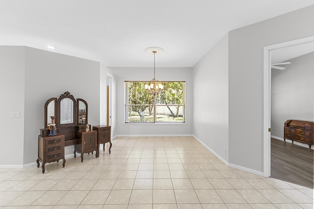 dining area featuring baseboards, a notable chandelier, and light tile patterned flooring