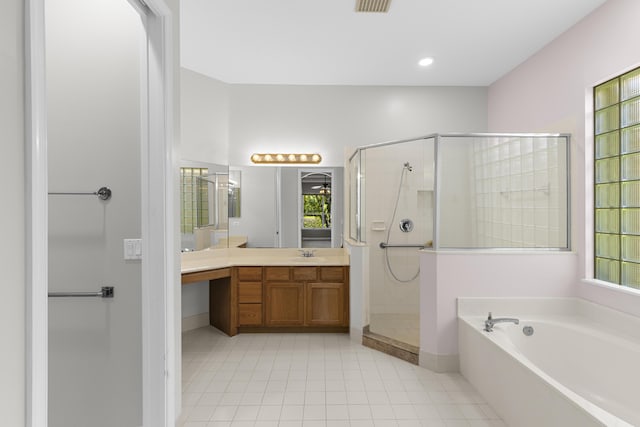 full bathroom featuring a healthy amount of sunlight, vanity, a shower stall, and a garden tub