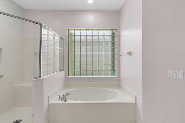 full bathroom with recessed lighting, a garden tub, and a stall shower