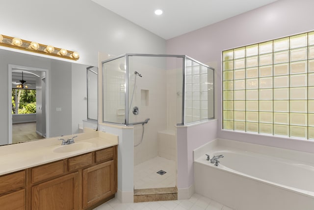 bathroom featuring tile patterned flooring, a shower stall, ceiling fan, a garden tub, and vanity