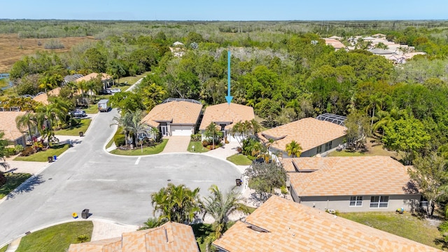 aerial view with a wooded view and a residential view