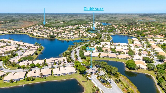 drone / aerial view with a water view and a residential view