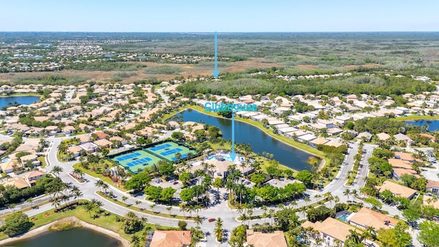 drone / aerial view with a residential view and a water view