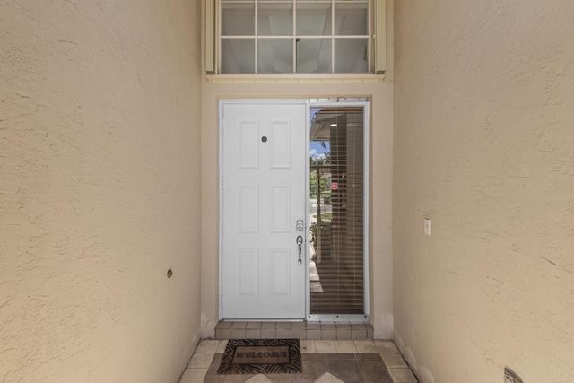 property entrance featuring stucco siding