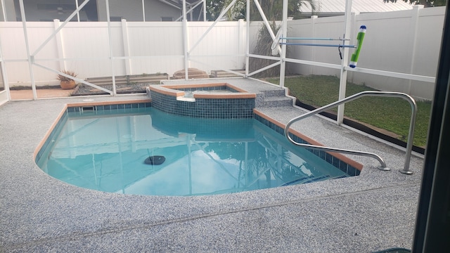 view of pool featuring a fenced in pool, an in ground hot tub, a fenced backyard, a lanai, and a patio area
