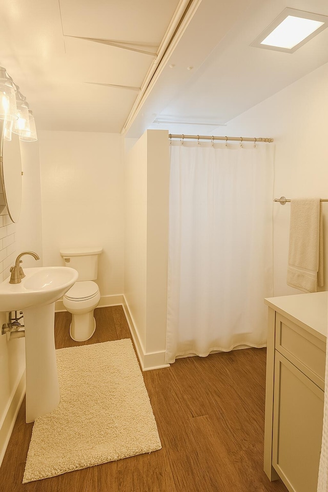 2076 E Main St, Pahokee, FL 33476 - bathroom featuring wood finished floors and curtained shower