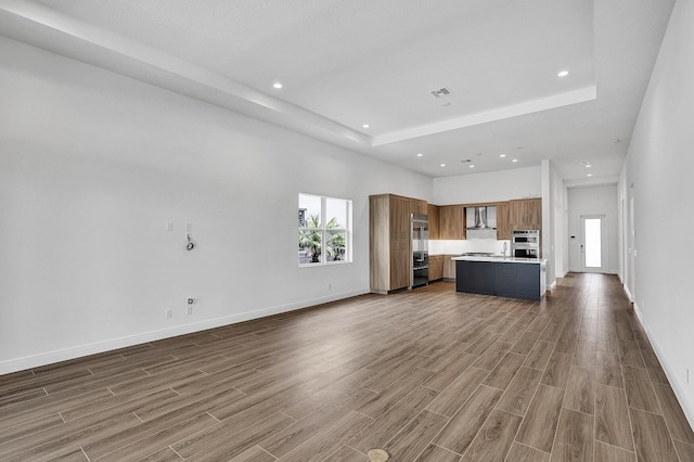 10064 Driftwood Way, Palm Beach Gardens, FL 33412 - unfurnished living room with wood finished floors, baseboards, recessed lighting, and a high ceiling