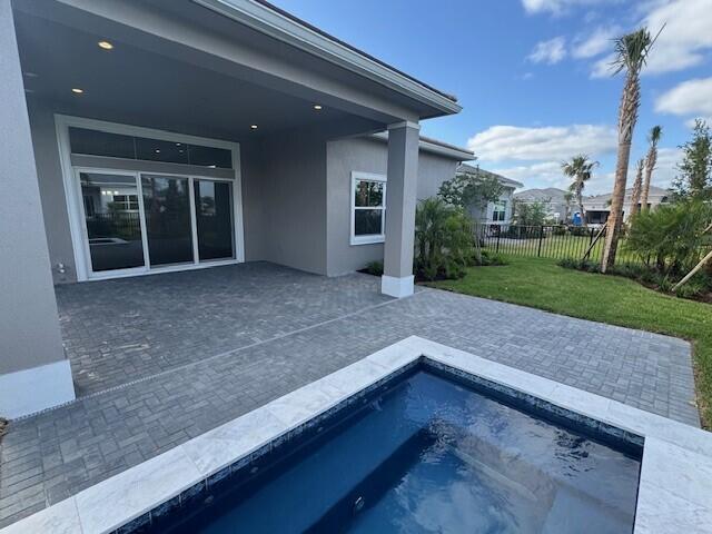 view of pool with a lawn, fence, a patio area, and a fenced in pool