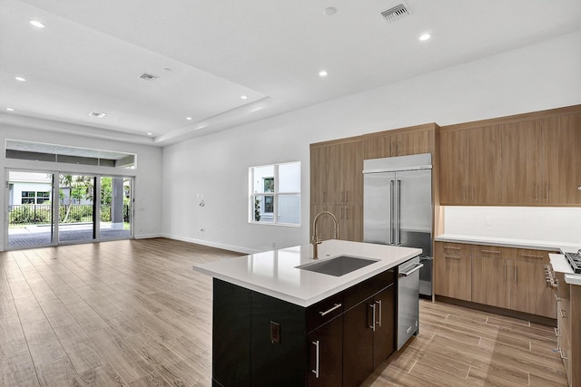 10064 Driftwood Way, Palm Beach Gardens, FL 33412 - kitchen with stainless steel appliances, light countertops, open floor plan, a sink, and recessed lighting