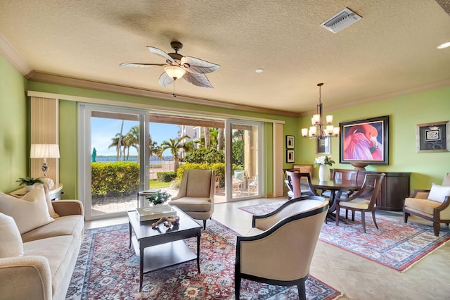 living area featuring visible vents, ornamental molding, light tile patterned floors, ceiling fan with notable chandelier, and a textured ceiling