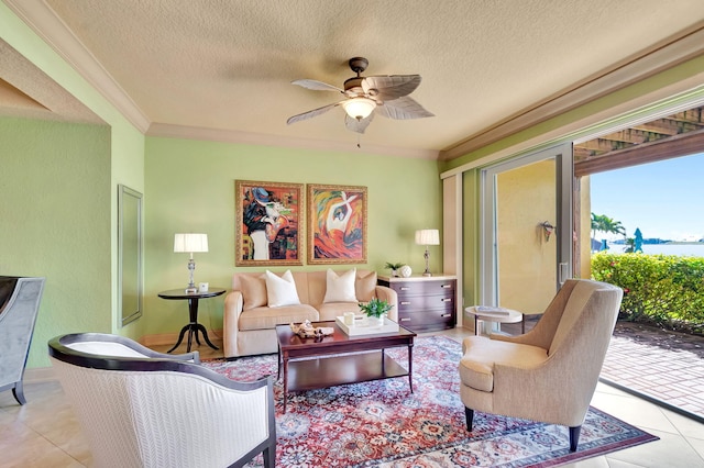 tiled living area with a textured ceiling, crown molding, and a ceiling fan