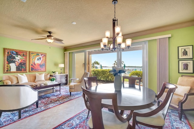 tiled dining area featuring ceiling fan with notable chandelier and a textured ceiling