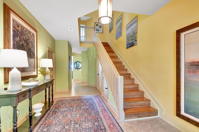 entryway featuring french doors and stairway