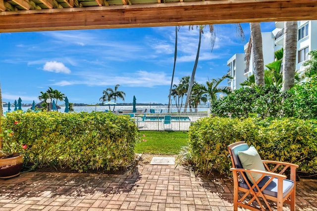 view of patio / terrace featuring a community pool and fence