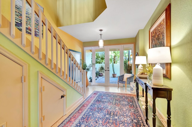 property entrance featuring french doors and stucco siding