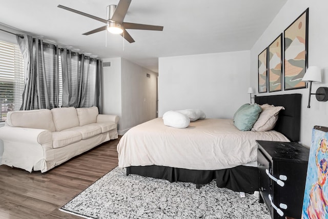 bedroom featuring visible vents, a ceiling fan, and wood finished floors