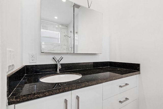 bathroom with recessed lighting and vanity