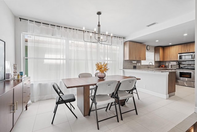 dining area featuring light tile patterned floors, a notable chandelier, visible vents, and recessed lighting