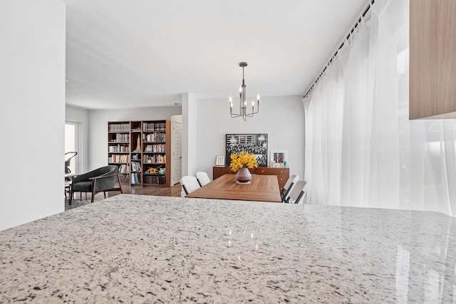 dining space with a chandelier and wood finished floors