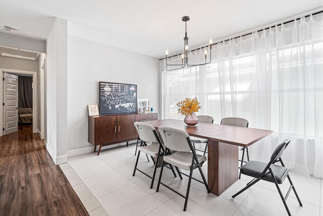 dining area featuring baseboards and an inviting chandelier