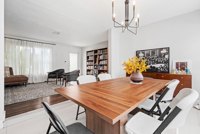 dining area with a notable chandelier and wood finished floors
