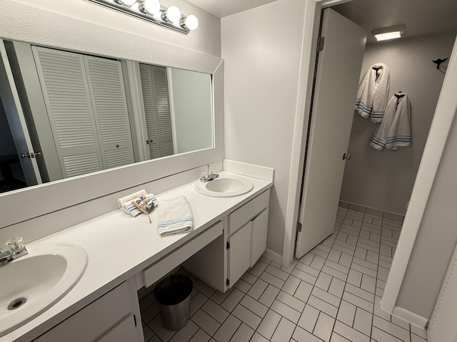 9407 S Ocean Dr Unit 1D, Jensen Beach, FL 34957 - bathroom with baseboards, double vanity, a closet, and brick patterned floors