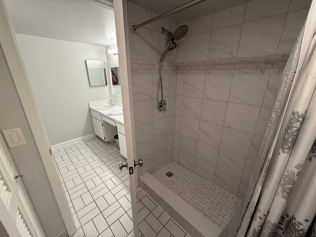 9407 S Ocean Dr Unit 1D, Jensen Beach, FL 34957 - full bathroom with a tile shower, baseboards, and vanity